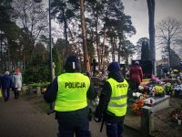 Policjanci zapewniający bezpieczeństwo na cmentarzu.