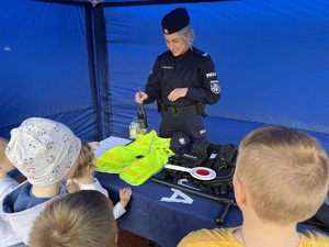 policjantka pokazuje dzieciom sprzęt służbowy